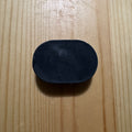 1 black oval soap on a wooden surface