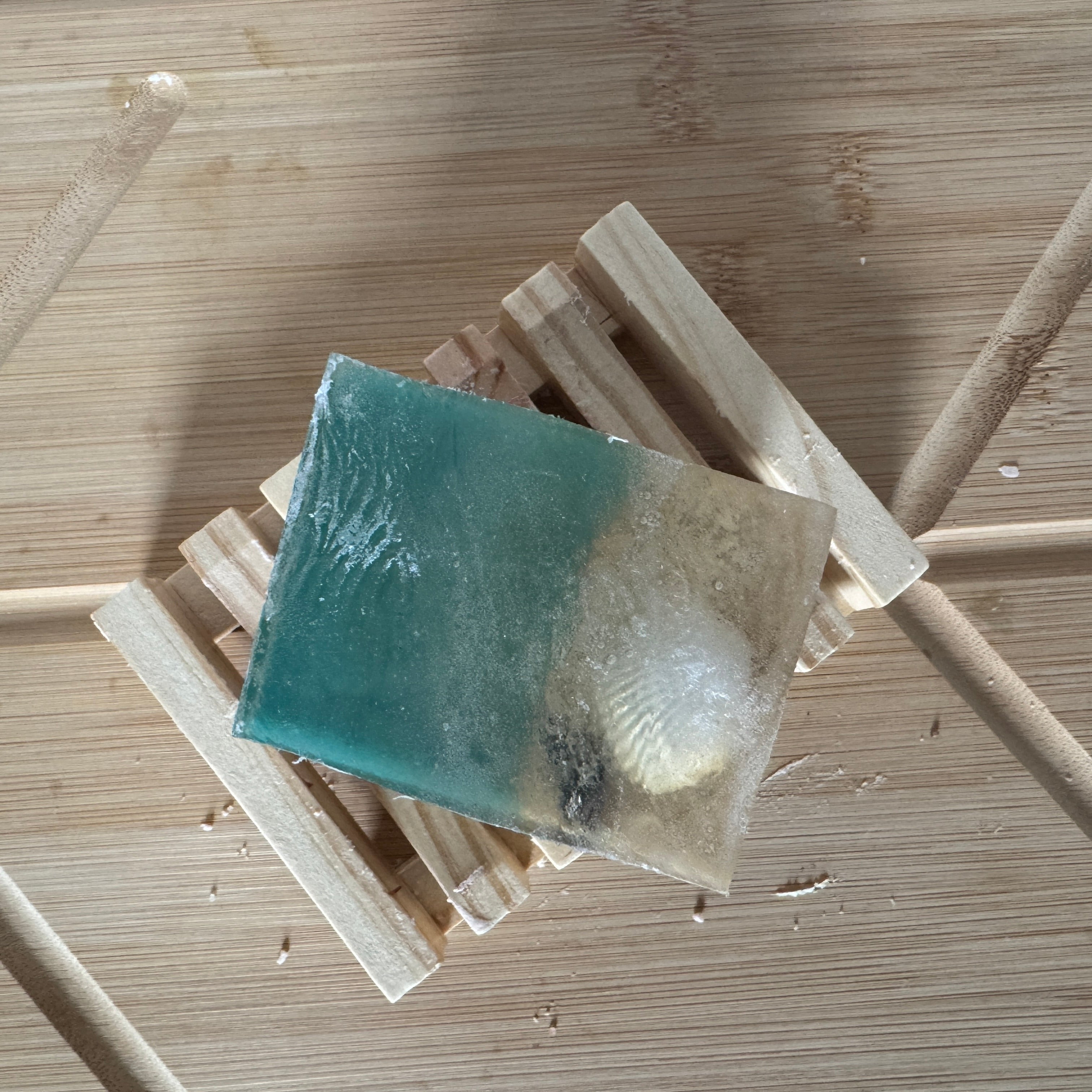 a large chunk of soap that looks like sand and water with sea shells.