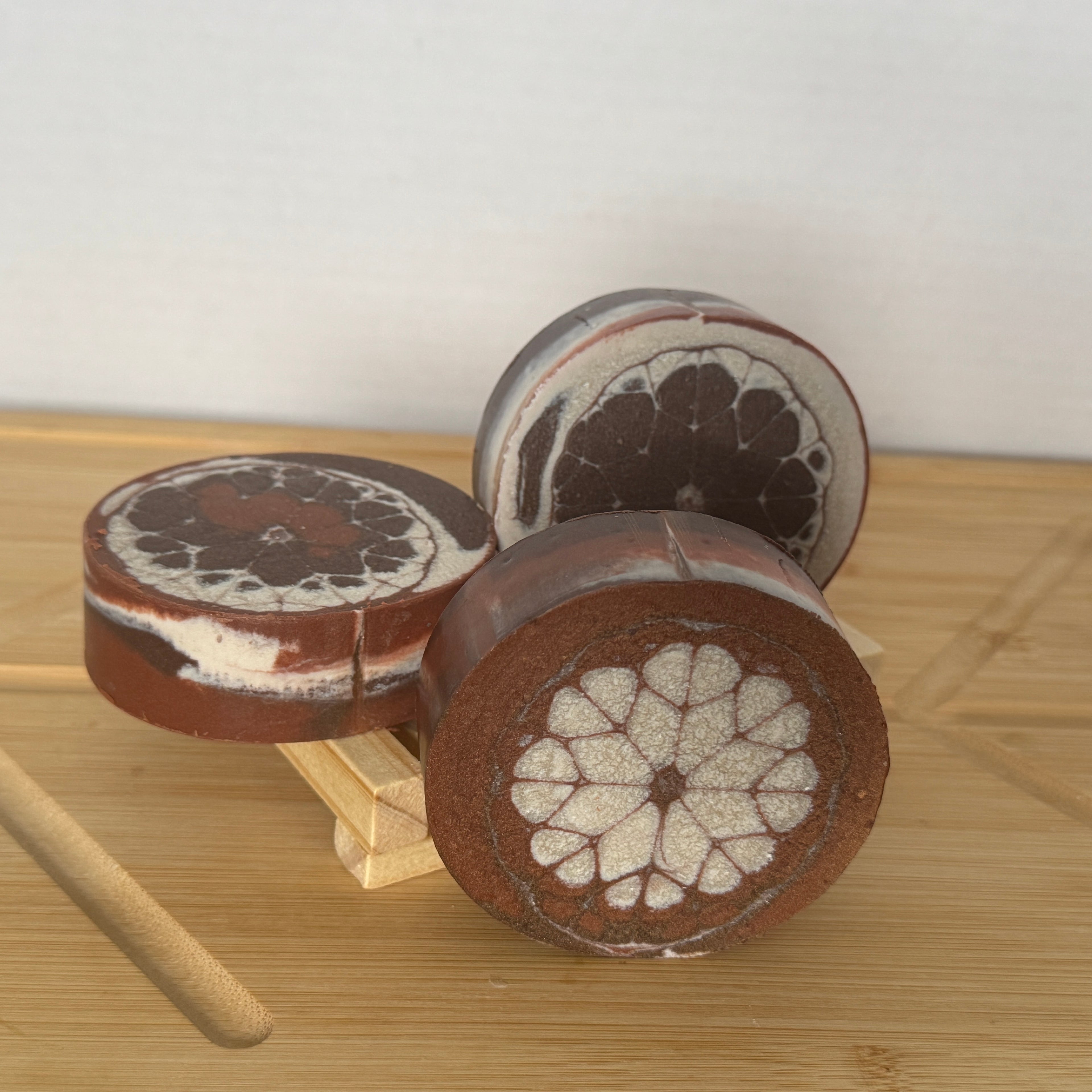brown and white design soap on a wood board.