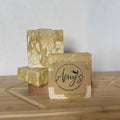 Three bars of soap with 'Amy's Handmade Soap' branding on a wooden surface.