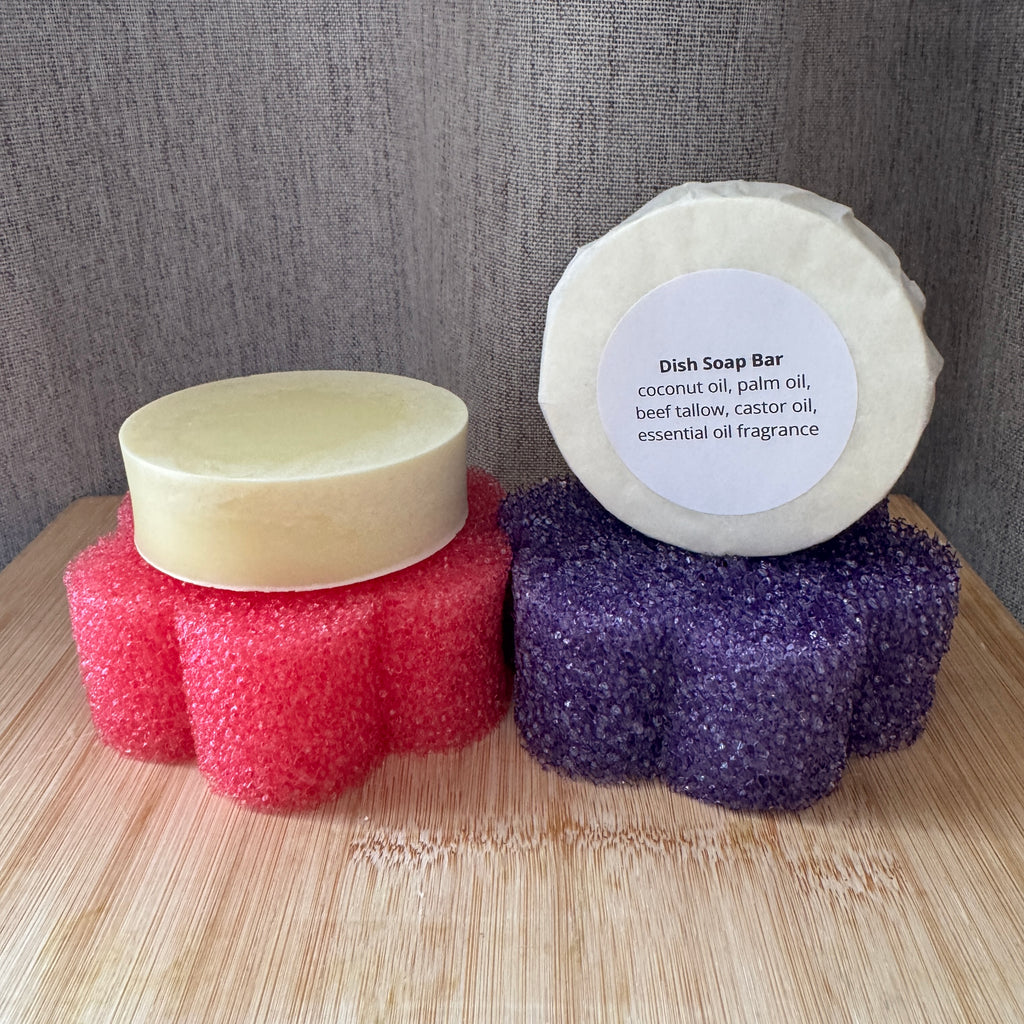 2 dish soap bars with different coloured sponges on a wooden surface.