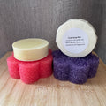 2 dish soap bars with different coloured sponges on a wooden surface.