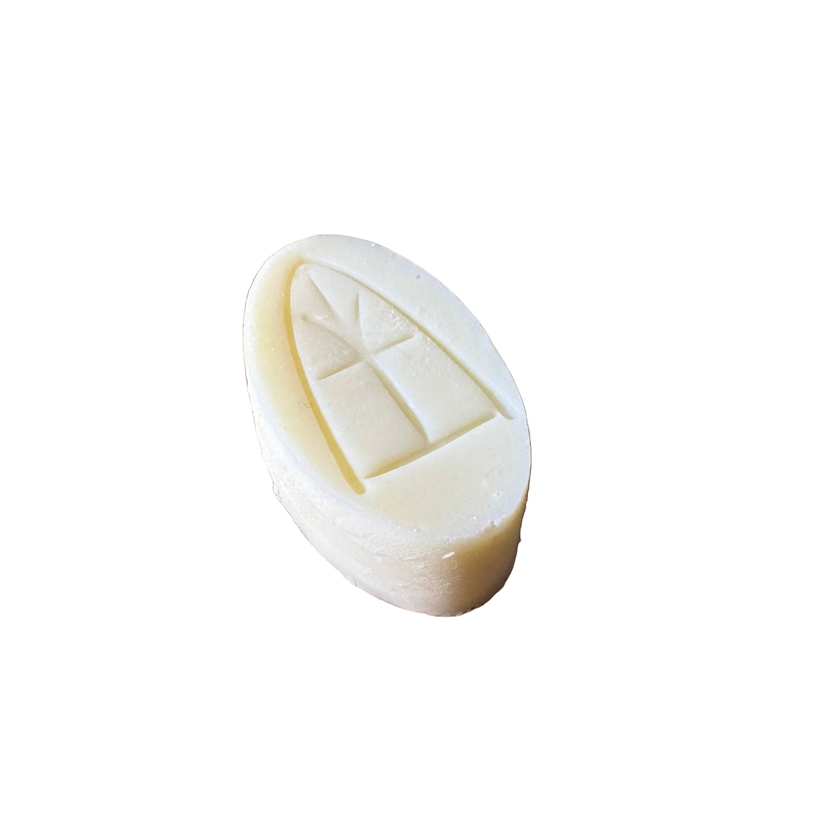 White soap bar with a unique design on a woven mat