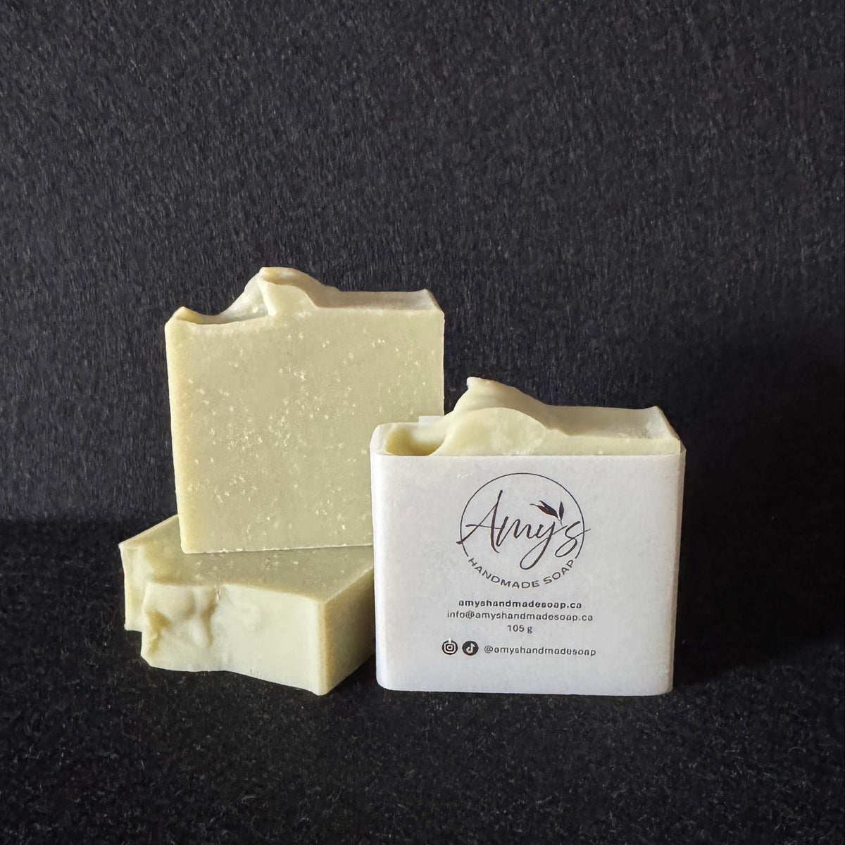 3 bars of handmade soap light green on a dark black background