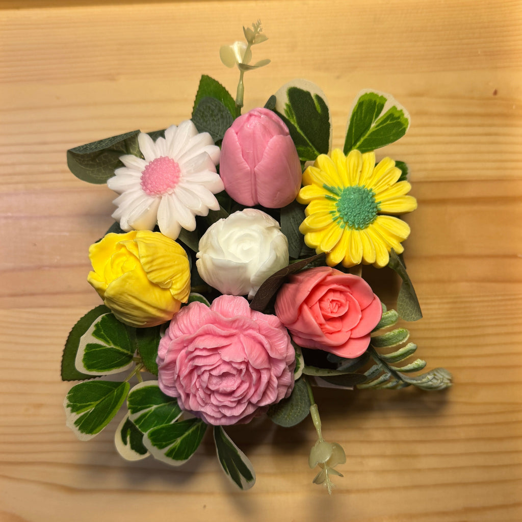 Colorful flower arrangement made of fondant on a wooden surface