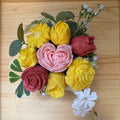 Bouquet of colorful soap flowers on a wooden surface
