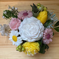 Bouquet of decorative flowers on a wooden surface