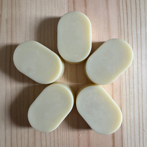 5 oval soaps on a wooden board