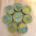 Marbled circular soaps on a wooden surface