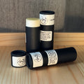 3 tubes of natural lip balm in black cardboard tubes