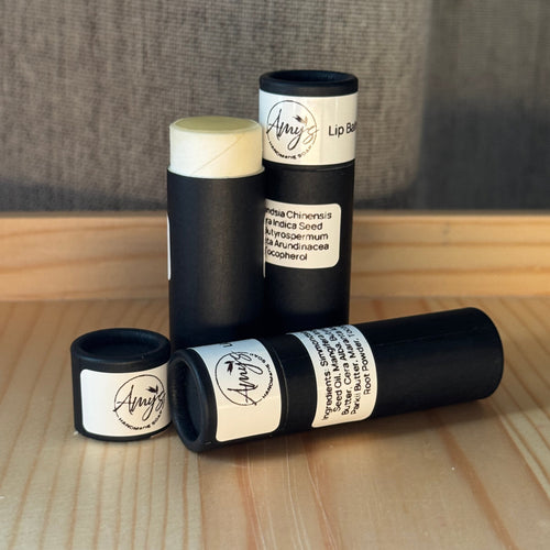 3 tubes of natural lip balm in black cardboard tubes
