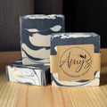 Handmade soap bars with a 'Amy's Handmade Soap' label on a wooden surface.