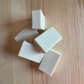 White soap bars on a wooden surface