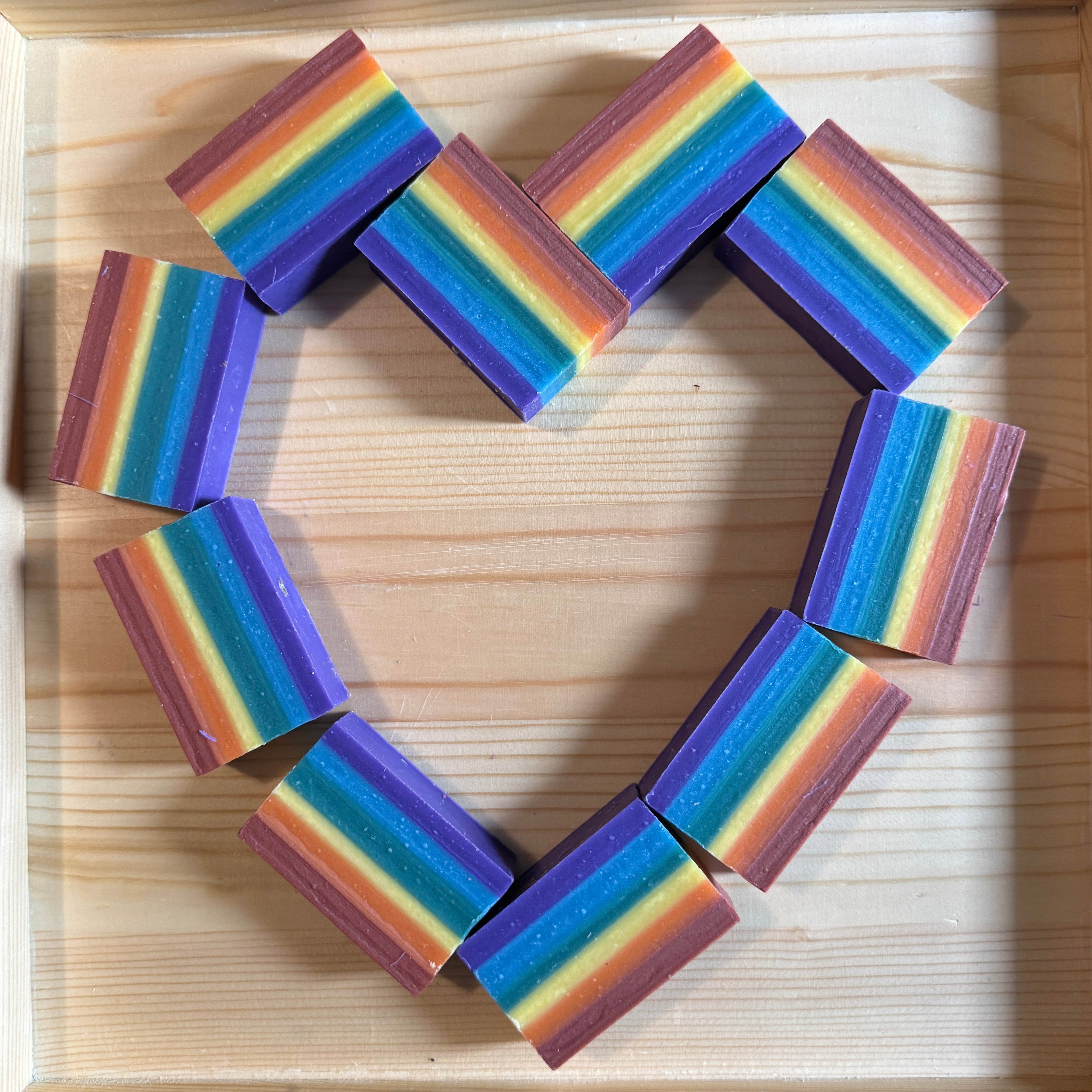 rainbow soaps arranged in a heart shape