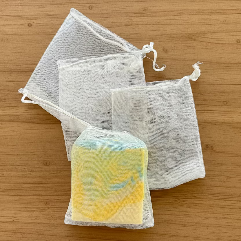 Mesh bags with a bar of soap on a dark background