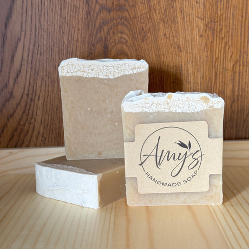Three bars of handmade soap with 'Amy's Handmade Soap' label on a wooden surface.