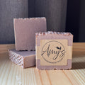 Handmade soap bars with 'Amy's Handmade Soap' label on a wooden surface.
