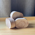 a set of oval shaped soaps on a wooden surface