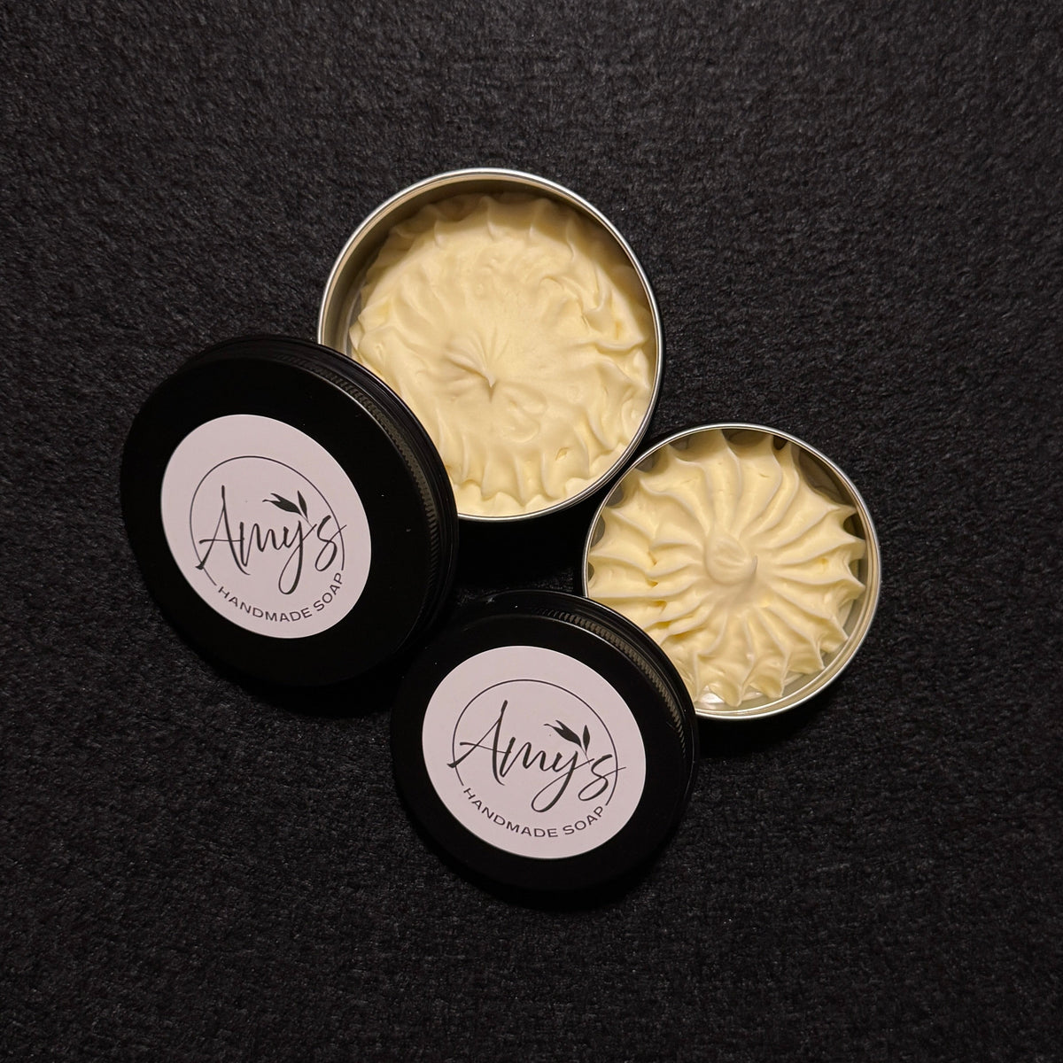 two black tins filled with spiraling butter